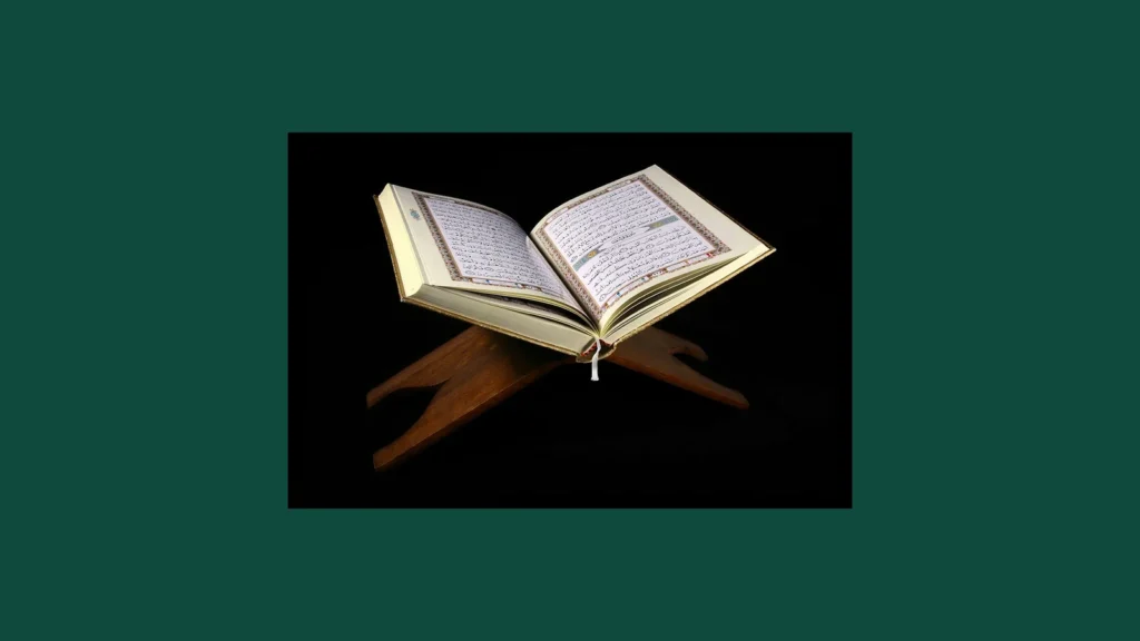 An open Quran resting on a wooden rehal, or book stand